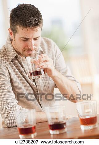 Stock Photo - Man tasting whiskey. Fotosearch