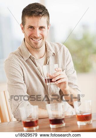 Stock Photo - Man tasting whiskey. Fotosearch
