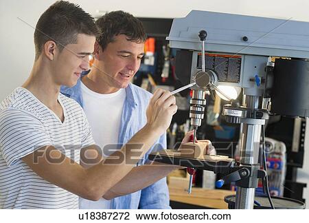 Man with teenage son (16-17) drilling in workshop View Large Photo Image Stock Image - Man with teenage son (16-17) drilling in workshop. Fotosearch