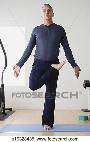 Mature man practicing yoga on mat View Large Photo Image Stock Photography - Mature man practicing yoga on mat. Fotosearch