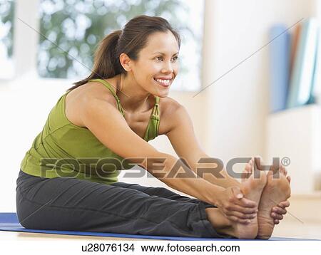 Mid adult woman training with dumbbell View Large Photo Image Picture - Mid adult woman training with dumbbell. Fotosearch