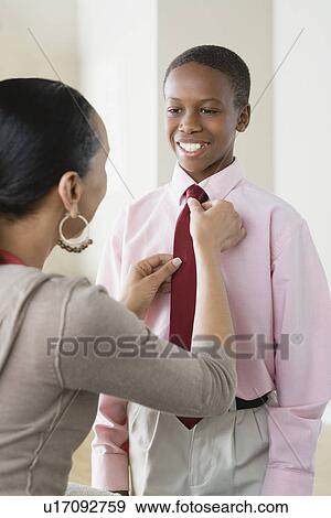 Mother adjusting Son's (12-13) tie View Large Photo Image Stock Photo - Mother adjusting Son's (12-13) tie. Fotosearch