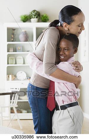 Mother and Son (12-13) hugging View Large Photo Image Stock Photograph - Mother and Son (12-13) hugging. Fotosearch
