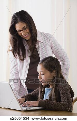 Picture - Mother doing homework with daughter (10-11). Fotosearch