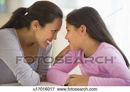 Stock Photo - Mother with daughter (10-11) talking at home. Fotosearch