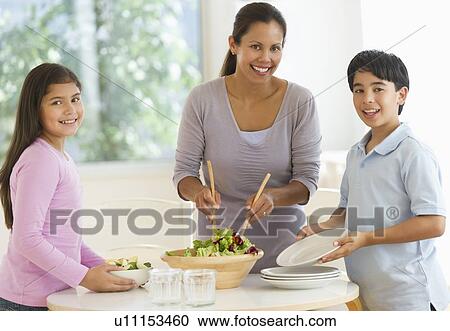 Mother with son (12-13) and daughter (10-11) preparing salad View Large Photo Image Stock Image - Mother with son (12-13) and daughter (10-11) preparing salad. Fotosearch