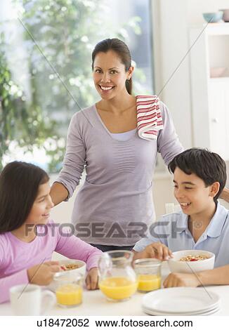 Mother with son (12-13) and daughter (10-11) having breakfast View Large Photo Image Stock Image - Mother with son (12-13) and daughter (10-11) having breakfast. Fotosearch