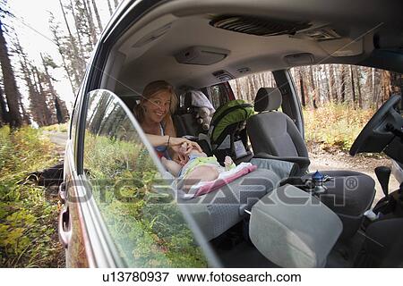 Mother with son (2-5 months) in car View Large Photo Image Stock Photo - Mother with son (2-5 months) in car. Fotosearch