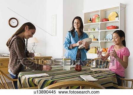 Mother with two daughters (8-9, 10-11) in kitchen View Large Photo Image Stock Photography - Mother with two daughters (8-9, 10-11) in kitchen. Fotosearch