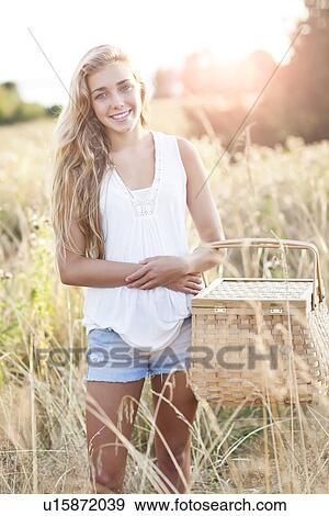 Outdoors portrait of teenage (16-17) with picnic basket View Large Photo Image Stock Photo - Outdoors portrait of teenage (16-17) with picnic basket . Fotosearch