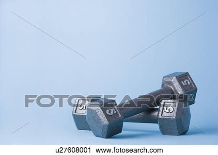 Pair of dumbbells on blue background View Large Photo Image Stock Image - Pair of dumbbells on blue background. Fotosearch