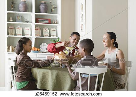 Parents and children (10-13) eating dinner together View Large Photo Image Stock Image - Parents and children (10-13) eating dinner together. Fotosearch