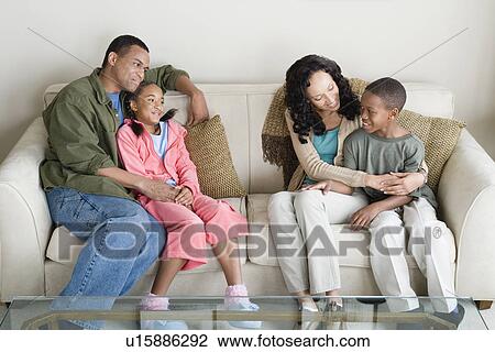 Parents with children (10-13) relaxing on sofa View Large Photo Image Stock Image - Parents with children (10-13) relaxing on sofa. Fotosearch
