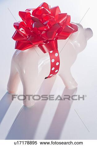 Piggy bank with big red ribbon View Large Photo Image Stock Photography - Piggy bank with big red ribbon. Fotosearch