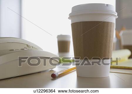 Picture - Plastic coffee cup on desk. Fotosearch