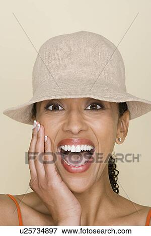 Stock Photo - Portrait of african american woman wearing hat. Fotosearch