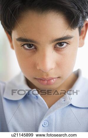 Stock Photo - Portrait of angry boy (12-13). Fotosearch