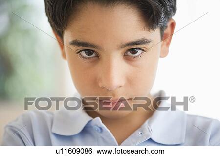 Stock Photograph - Portrait of angry boy (12-13). Fotosearch