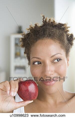 Portrait of attractive woman holding apple View Large Photo Image Stock Image - Portrait of attractive woman holding apple. Fotosearch