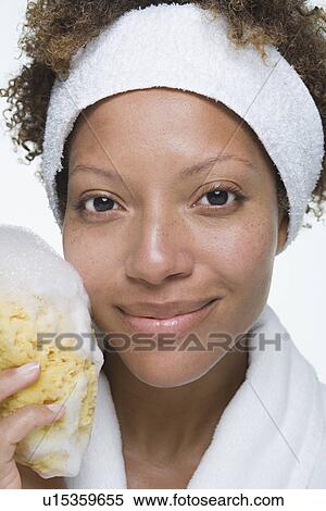 Portrait of attractive woman holding bath sponge View Large Photo Image Stock Photography - Portrait of attractive woman holding bath sponge. Fotosearch