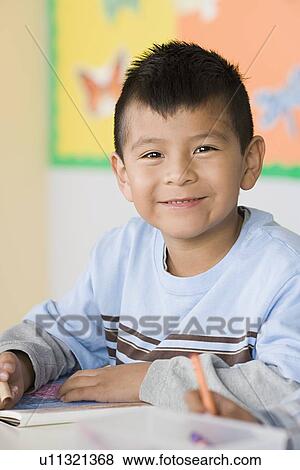 Portrait of boy (6-7) in classroom View Large Photo Image Stock Photo - Portrait of boy (6-7) in classroom. Fotosearch
