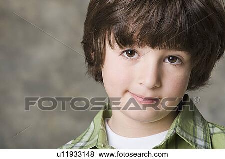 Stock Photo - Portrait of boy (6-7)r, studio shot. Fotosearch