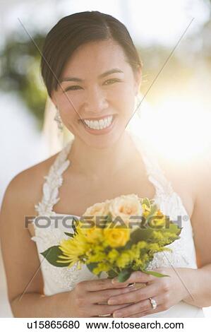 Portrait of bride holding bouquet View Large Photo Image Stock Image - Portrait of bride holding bouquet. Fotosearch