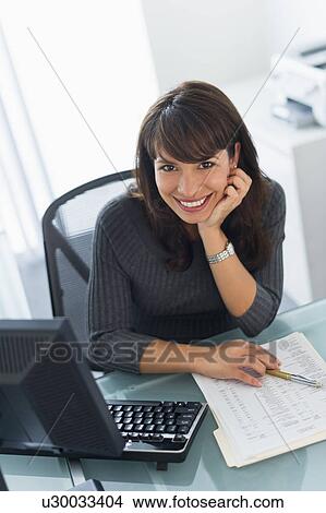 Picture - Portrait of business woman at desk. Fotosearch