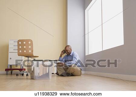 Portrait of businessman sitting on floor in empty office View Large Photo Image Stock Photo - Portrait of businessman sitting on floor in empty office. Fotosearch
