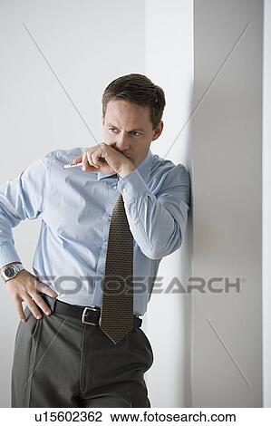 Stock Image - Portrait of businessman standing. Fotosearch