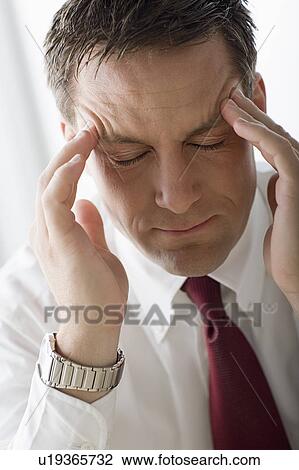 Portrait of businessman touching his head View Large Photo Image Stock Image - Portrait of businessman touching his head. Fotosearch
