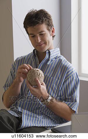 Portrait of businessman with ball of wool View Large Photo Image Stock Image - Portrait of businessman with ball of wool. Fotosearch