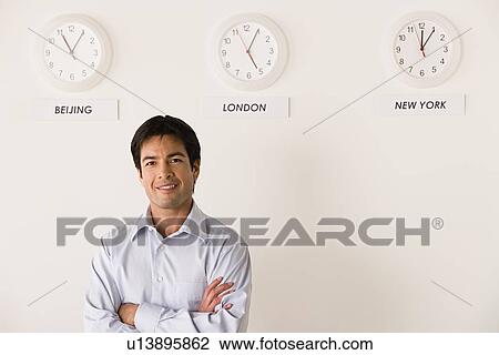Portrait of businessman with world clocks behind View Large Photo Image Stock Image - Portrait of businessman with world clocks behind. Fotosearch
