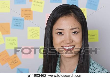 Stock Image - Portrait of businesswoman in office. Fotosearch