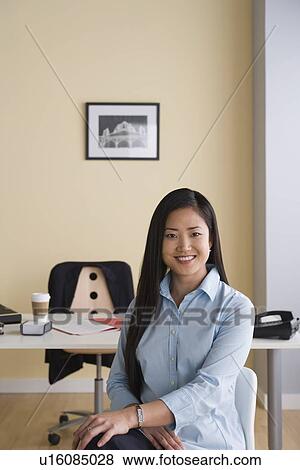 Stock Photo - Portrait of businesswoman in office. Fotosearch