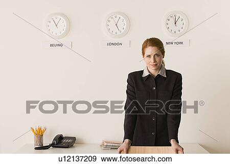 Portrait of businesswoman with world clocks behind View Large Photo Image Stock Photo - Portrait of businesswoman with world clocks behind. Fotosearch