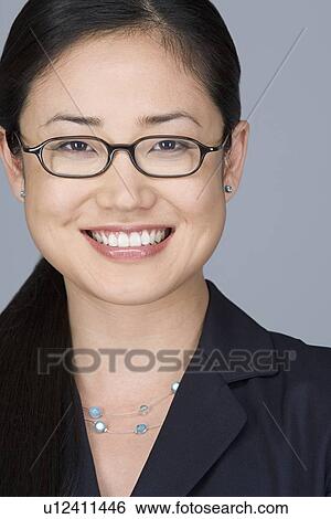 Stock Photograph - Portrait of cheerful young businesswoman. Fotosearch