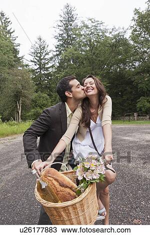 Portrait of couple on bike with basket View Large Photo Image Stock Image - Portrait of couple on bike with basket. Fotosearch