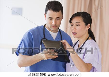 Portrait of doctor and nurse using digital tablet View Large Photo Image Stock Photo - Portrait of doctor and nurse using digital tablet. Fotosearch