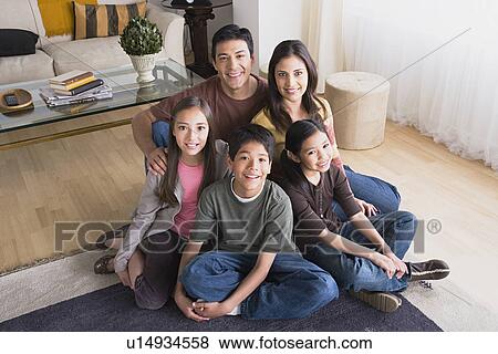 Stock Photo - Portrait of family with three children (8-9, 10-11). Fotosearch