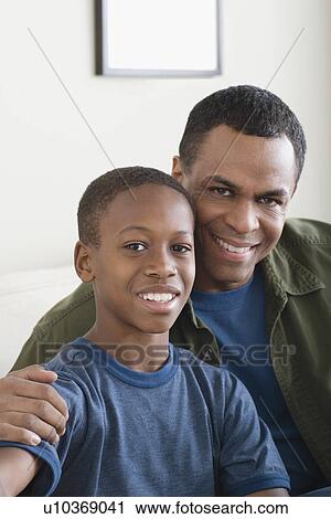 Stock Image - Portrait of Father and Son (12-13). Fotosearch