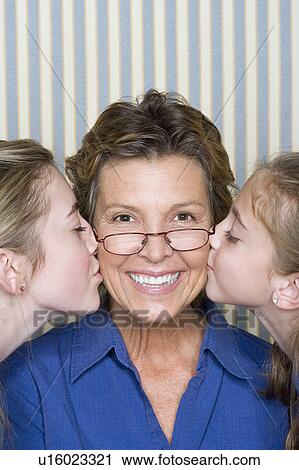 Portrait of father being kissed by two girls (8-9, 14-15) View Large Photo Image Stock Image - Portrait of father being kissed by two girls (8-9, 14-15) . Fotosearch
