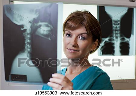 Portrait of female doctor looking at x-ray View Large Photo Image Stock Image - Portrait of female doctor looking at x-ray. Fotosearch