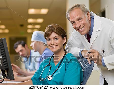 Portrait of female surgeon and male doctor View Large Photo Image Stock Photo - Portrait of female surgeon and male doctor. Fotosearch