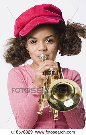 Portrait of girl (8-9) playing trumpet, studio shot View Large Photo Image Stock Photo - Portrait of girl (8-9) playing trumpet, studio shot. Fotosearch