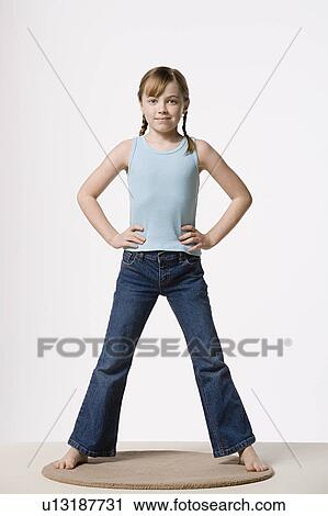 Portrait of girl (8-9) with hands on hips, studio shot View Large Photo Image Stock Image - Portrait of girl (8-9) with hands on hips, studio shot. Fotosearch