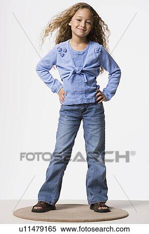 Portrait of girl (8-9) with hands on hips, studio shot View Large Photo Image Stock Photography - Portrait of girl (8-9) with hands on hips, studio shot. Fotosearch
