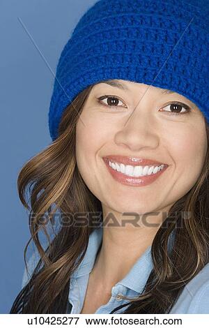 Portrait of happy asian woman wearing blue knit hat View Large Photo Image Stock Photo - Portrait of happy asian woman wearing blue knit hat. Fotosearch