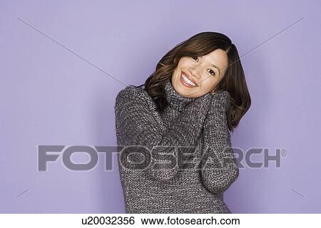 Stock Photograph - Portrait of happy asian woman wearing wooly jumper. Fotosearch