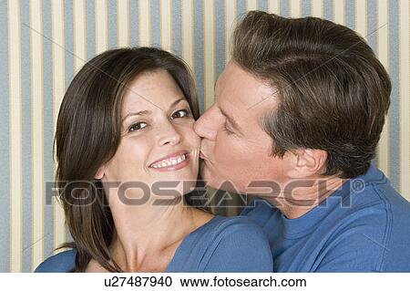 Stock Image - Portrait of happy couple dressed in blue. Fotosearch